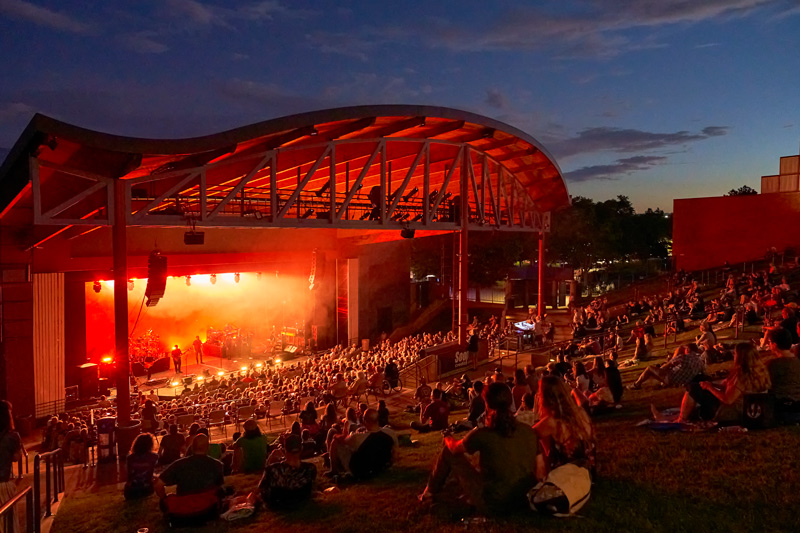 A night time concert happening at The Arvada Center's Outdoor Amphitheatre