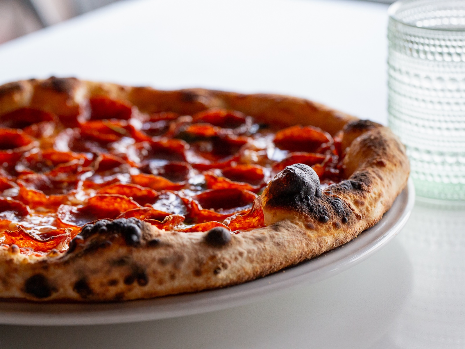 A pepperoni pizza with a blistered crush