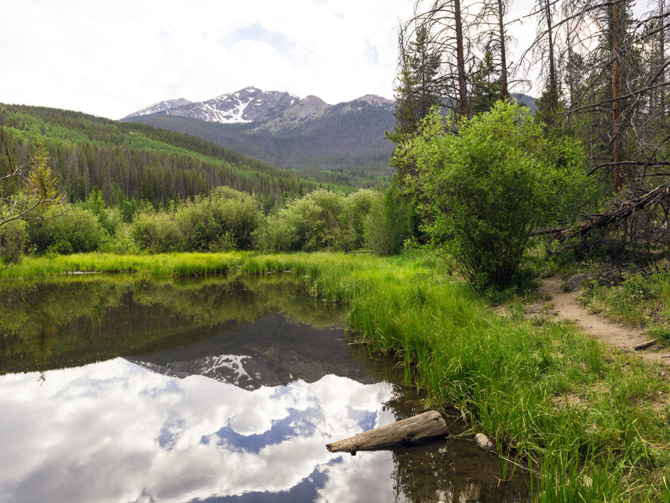 The Tenmile Range reflects into Rainbow Lake in Frisco, Colorado