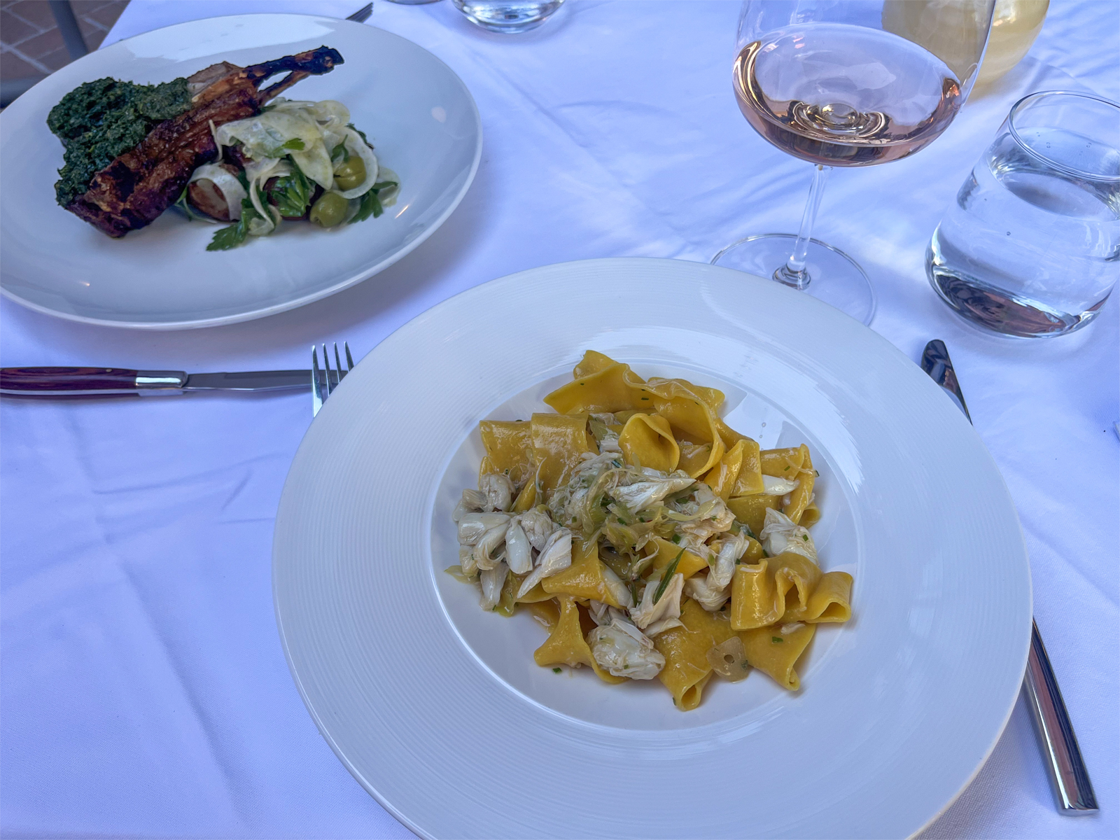pasta and meat dish on dining table