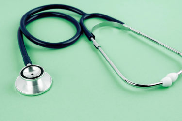 A stethoscope on mint green