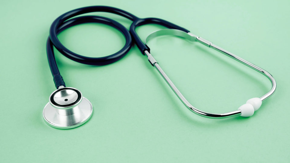 A stethoscope on mint green