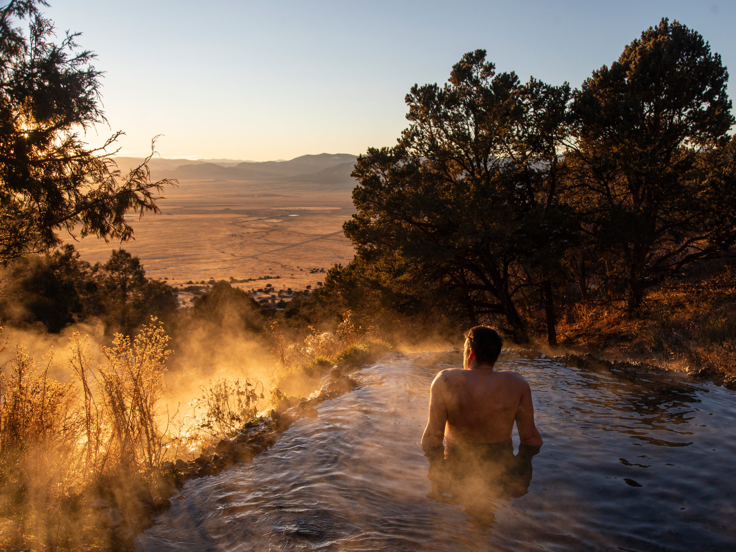 A man soaking at Valley View Hot Springs