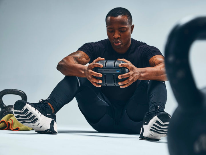 Man sits on the floor holding the ROCC in his hands