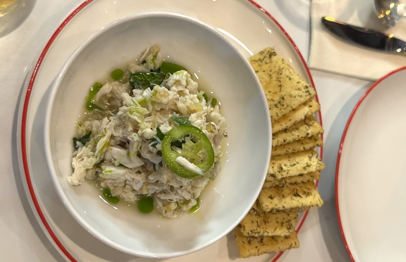 Crab salad in a bowl with a side of saltine crackers