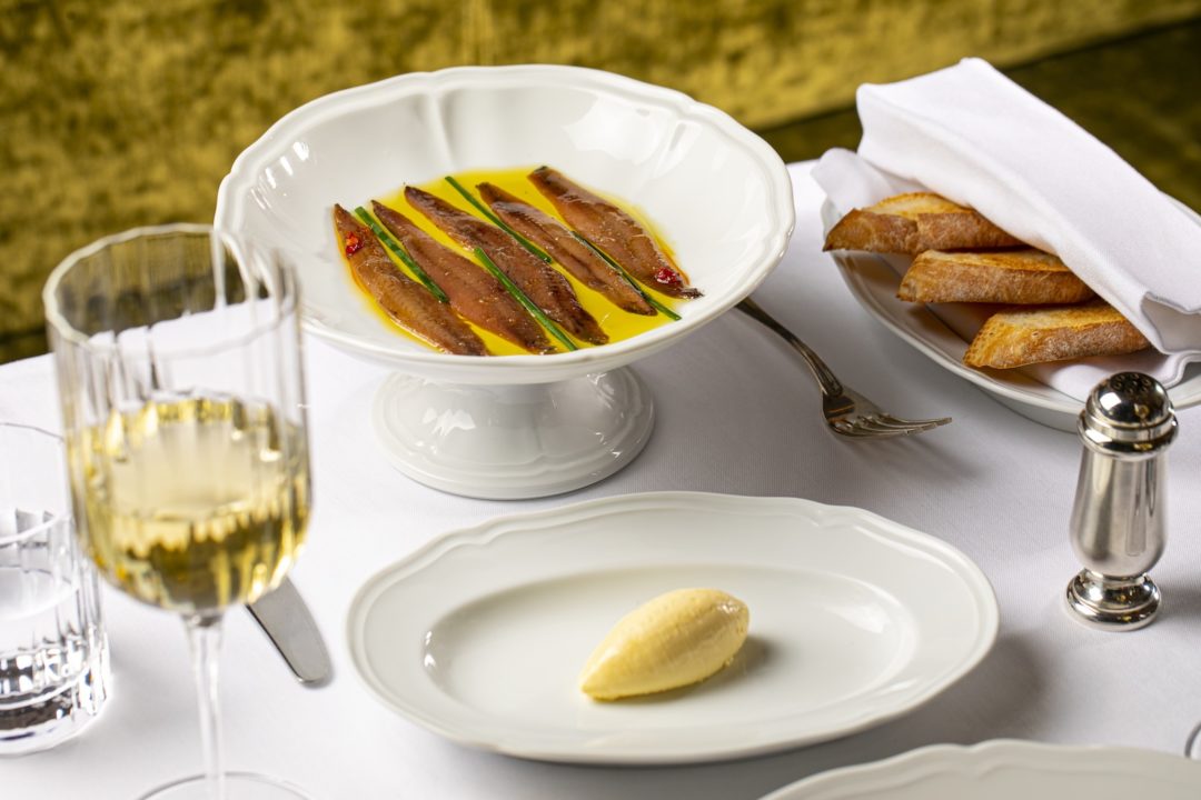 Fancy restaurant appetizers on white plates.