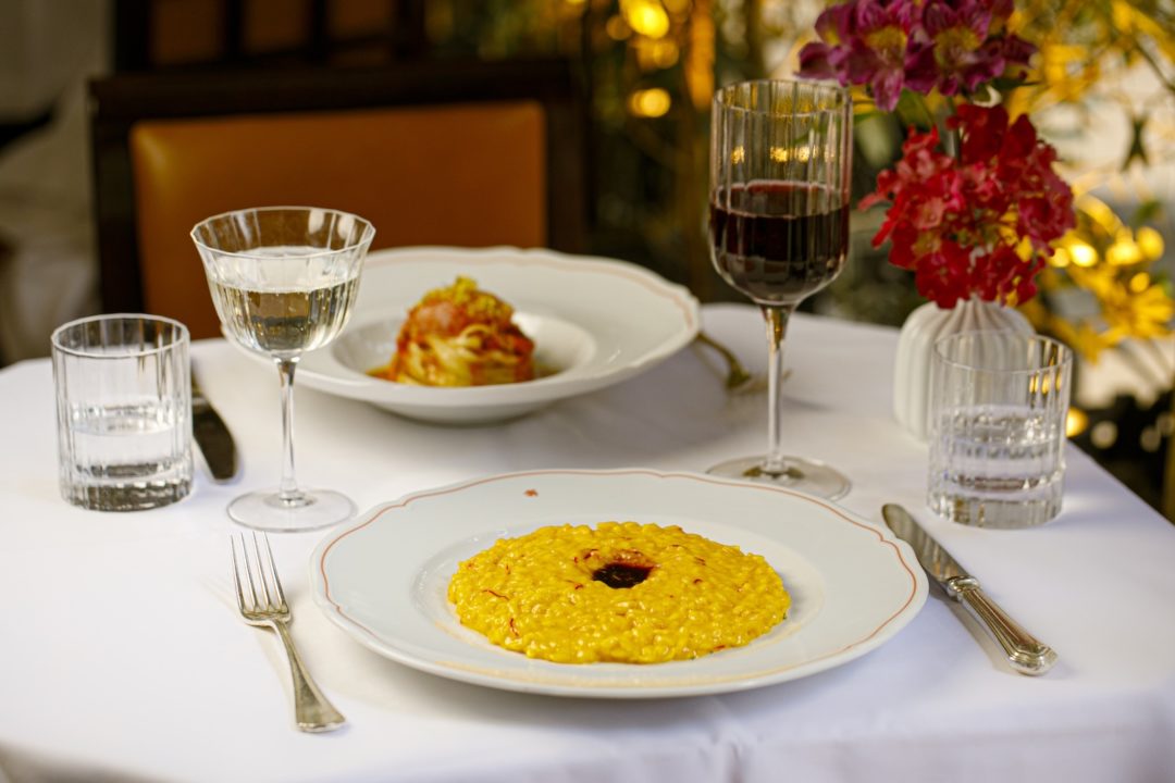 Saffron infused risotto in a wide shallow bowl