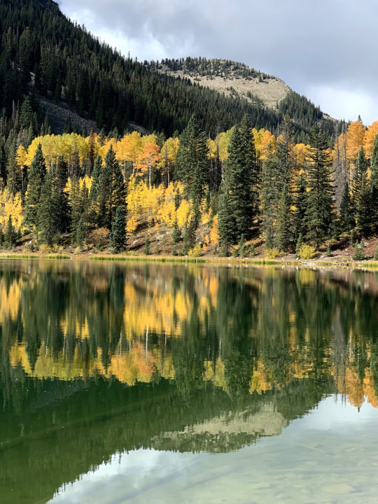 Aspen trees reflected into Lost Lake on the Three Lakes Loop