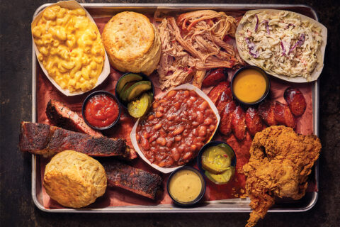 Pulled pork and brisket and fried chicken, surrounded by a bunch of sides like mac and cheese