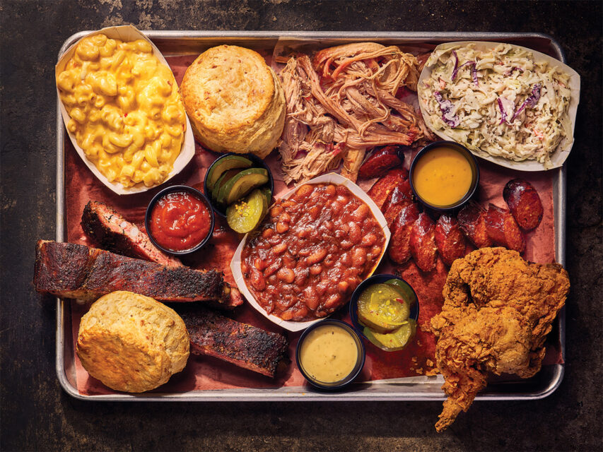 Pulled pork and brisket and fried chicken, surrounded by a bunch of sides like mac and cheese