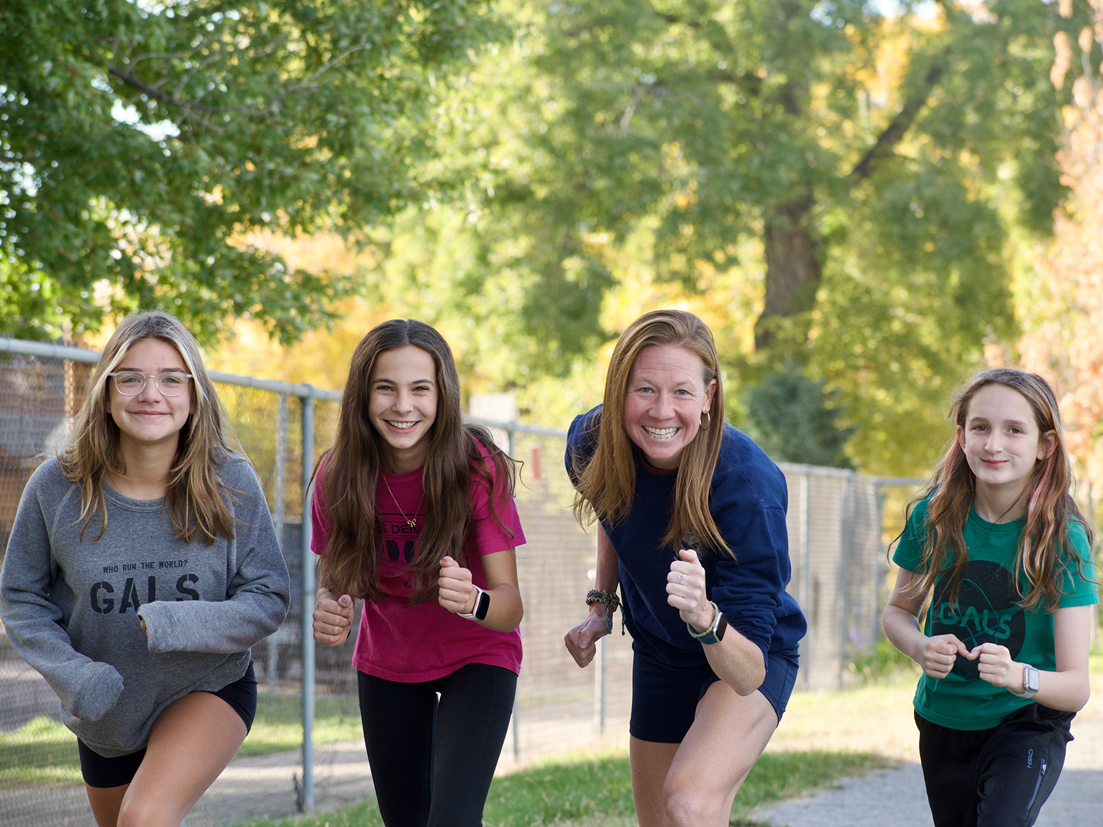 Female principal poses with three other students at GALS