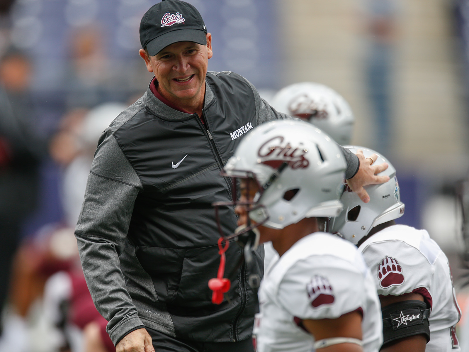 Bob Stitt greets his Montana players