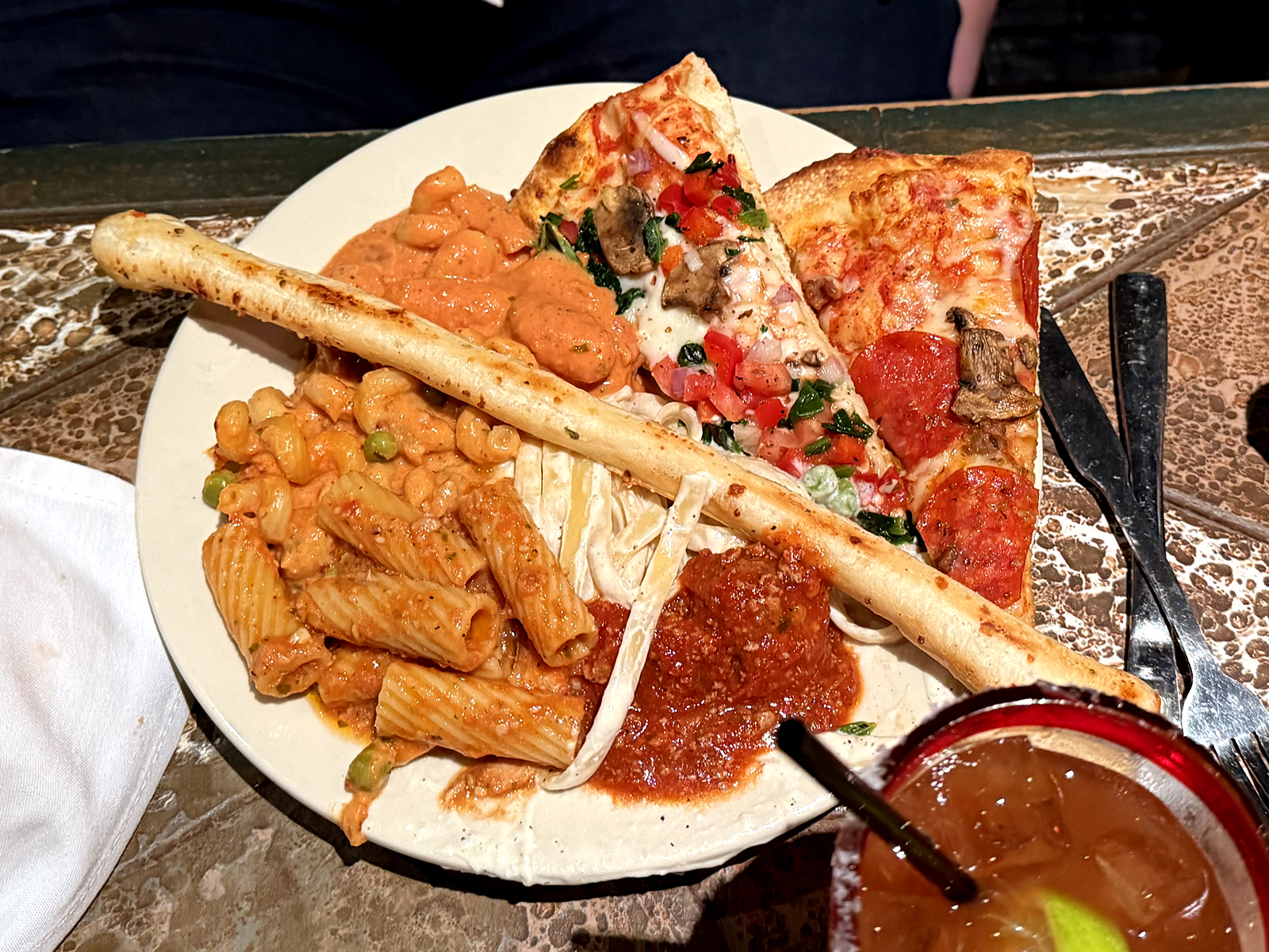 A plate overflowing with Italian food from Cinzzetti’s