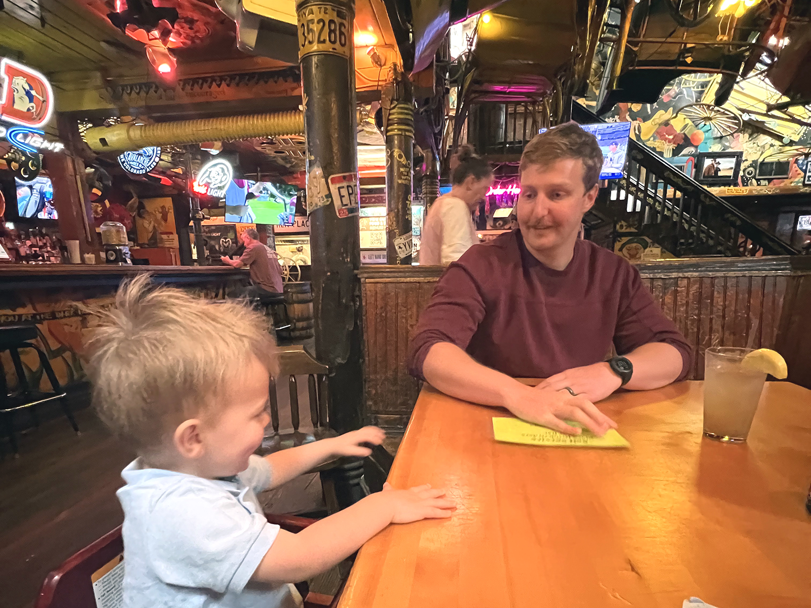 A little boy and an adult male at the Dark Horse in Boulder