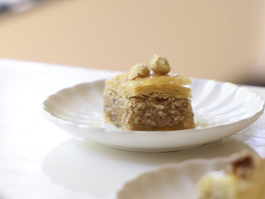 A piece of baklava on a white plate