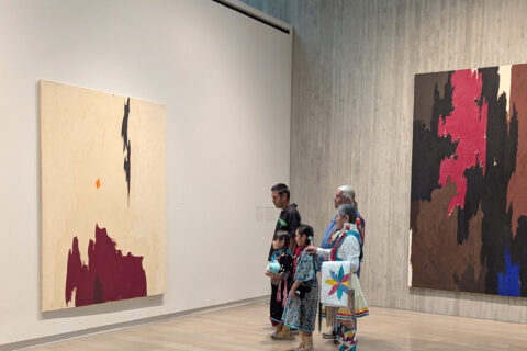 A family looking at paintings in a museum