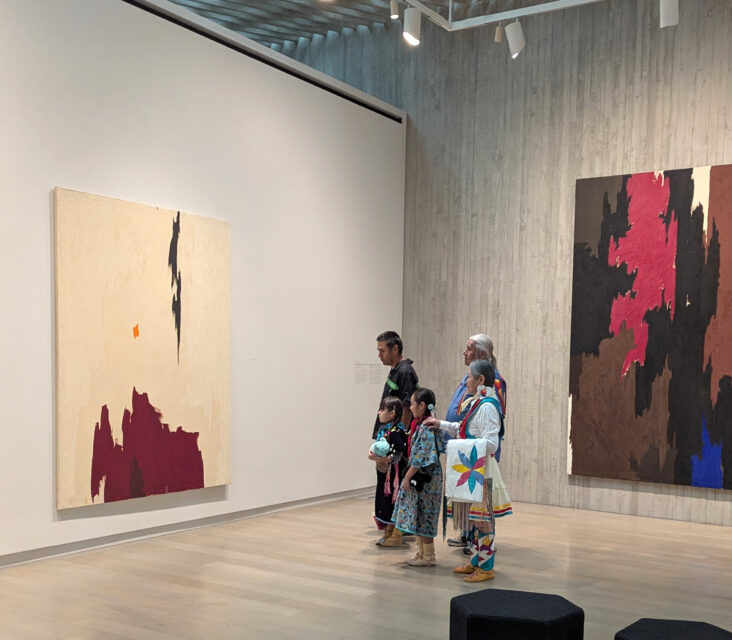 A family looking at paintings in a museum