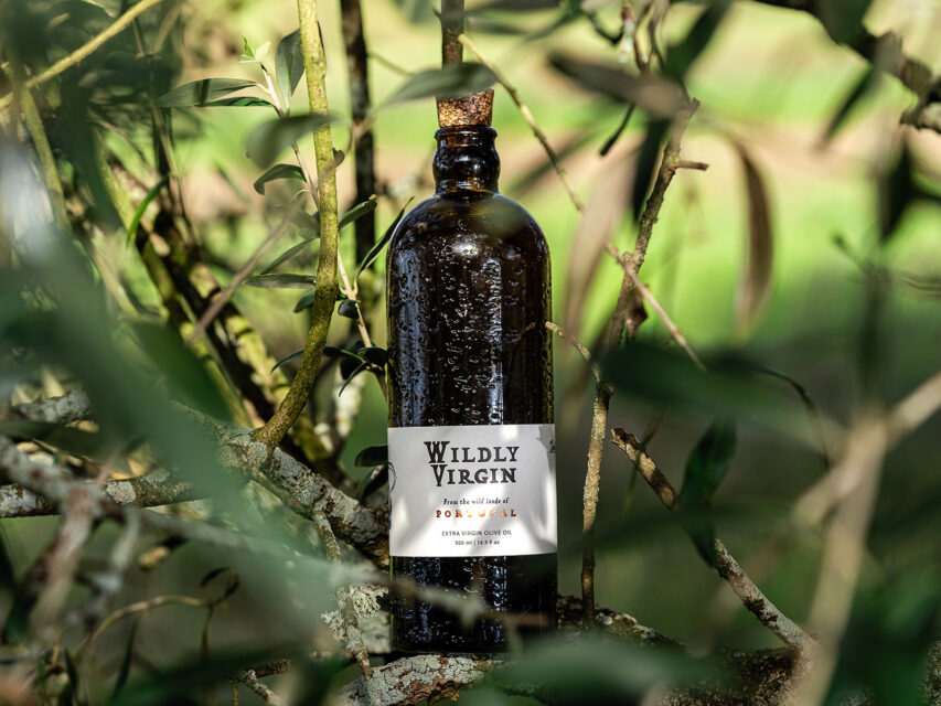 A bottle of Wildly Virgin extra-virgin olive oil in an olive tree