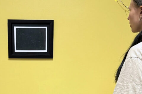 “Helsinki” by artist Gora hanging on a yellow wall