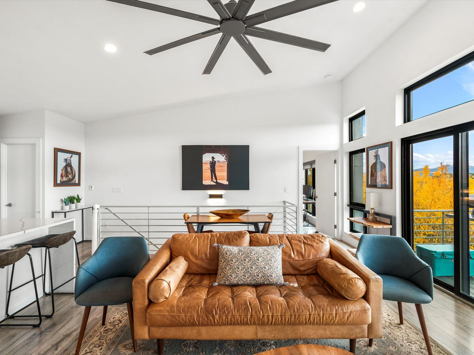 Upstairs sitting area with a big fan and seating area