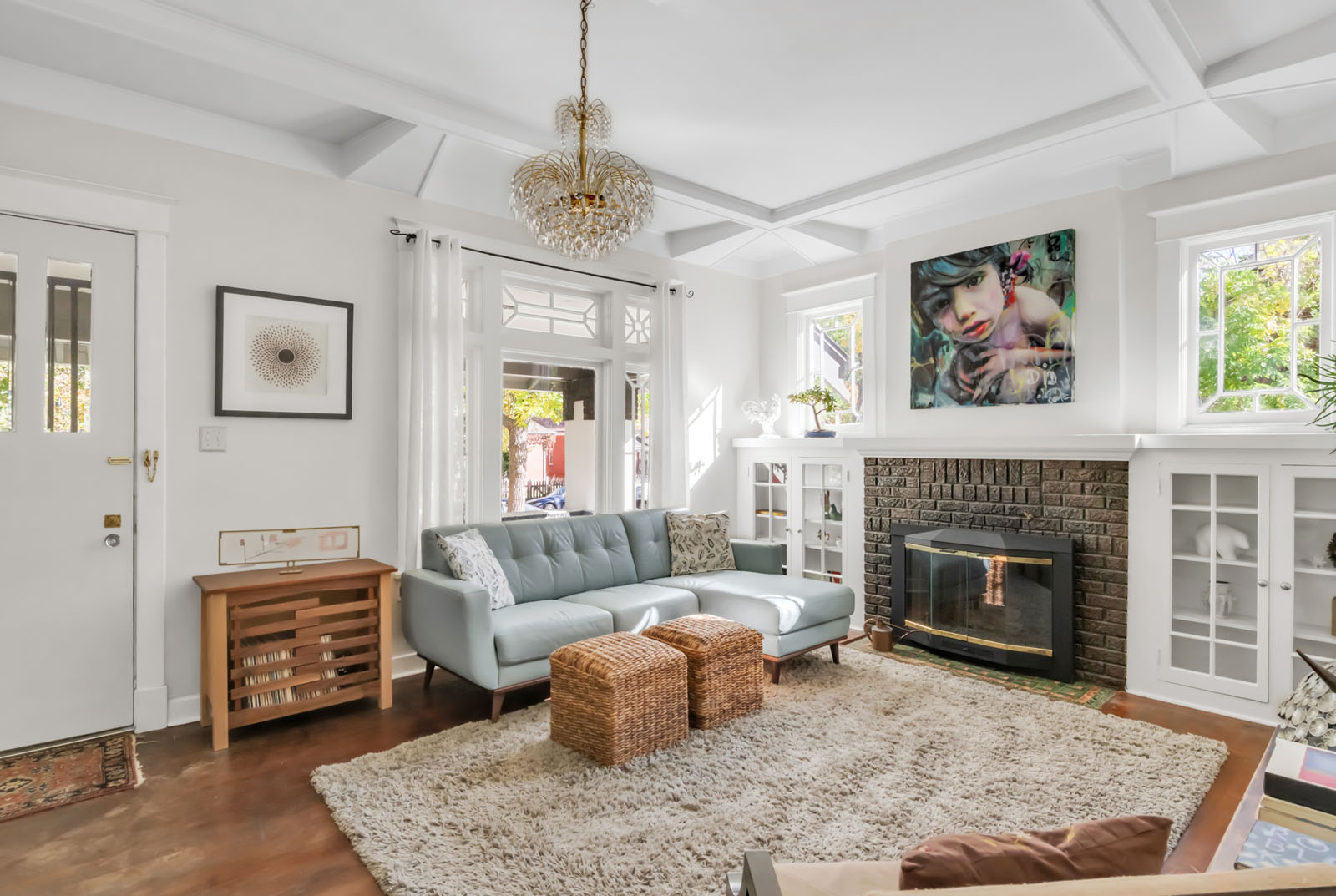 Living room with a fireplace and chandelier