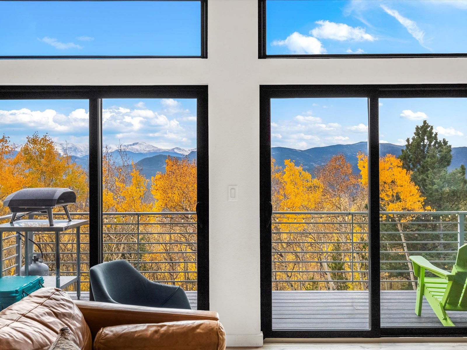 Floor-to-ceiling windows with fall foliage outside