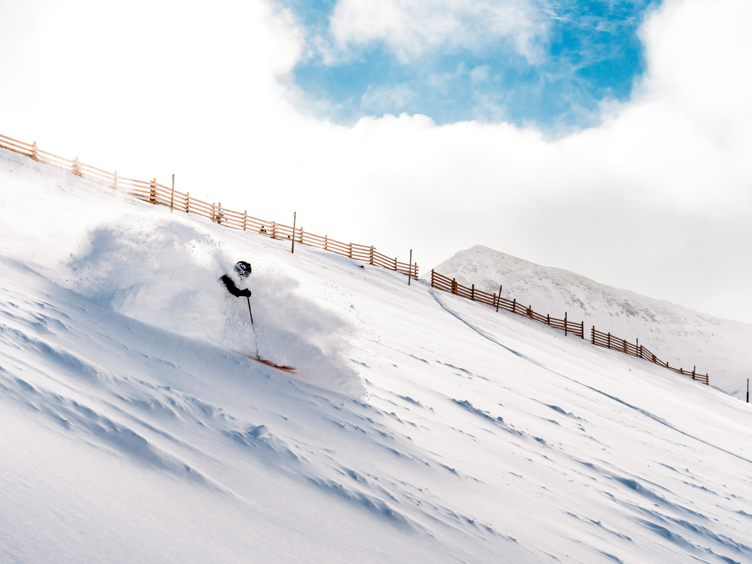 A skier slicing through powder at Arapahoe Basin in Colorado