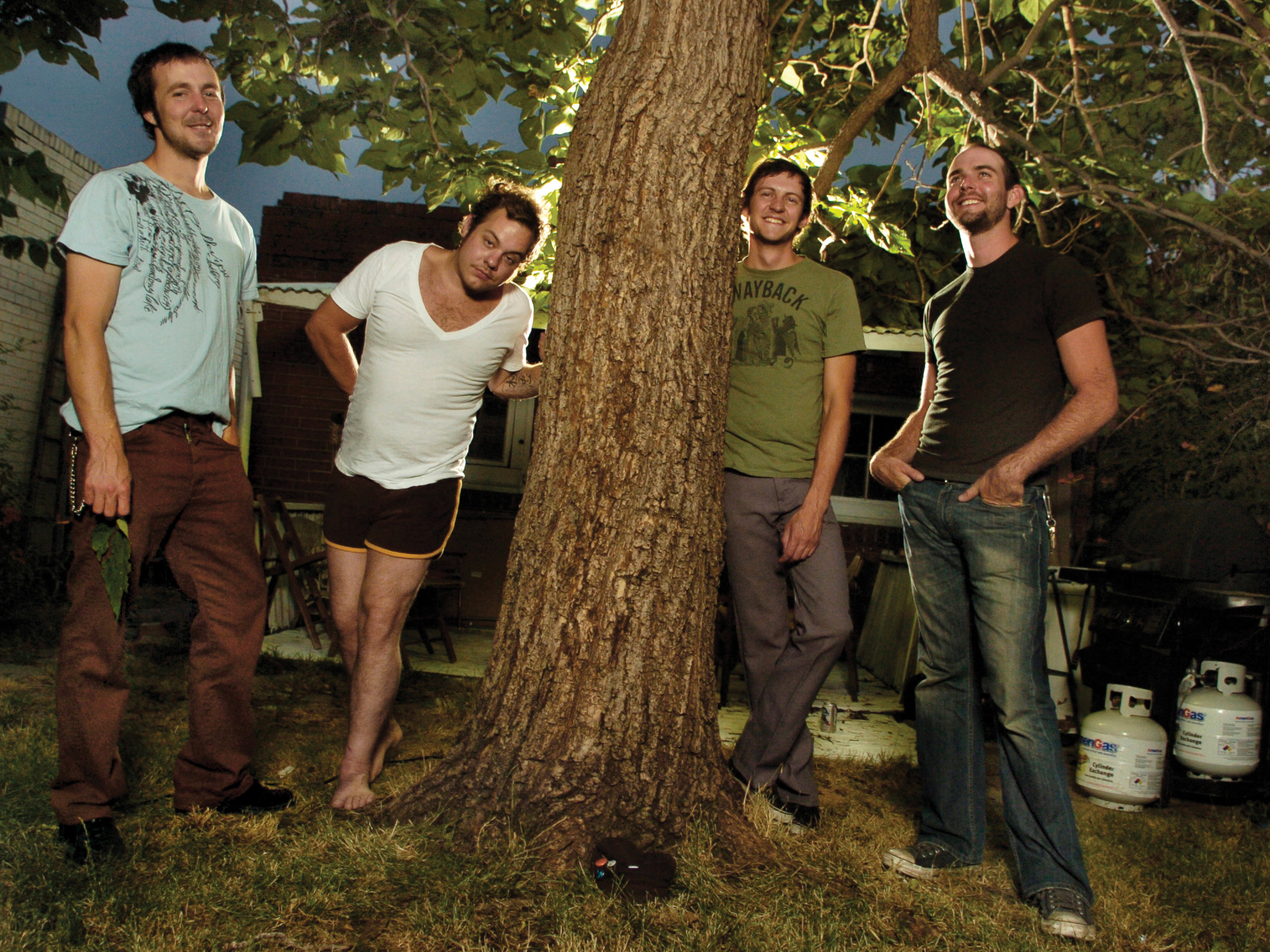 Rateliff and Joseph Pope III outside by a tree as members of Born in the Flood