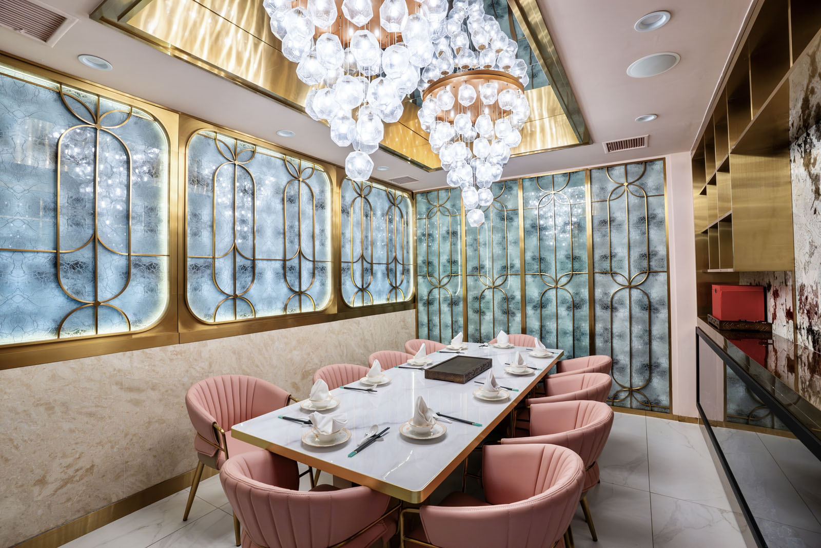Private dining room with cascading chandeliers and freen tiles on the wall
