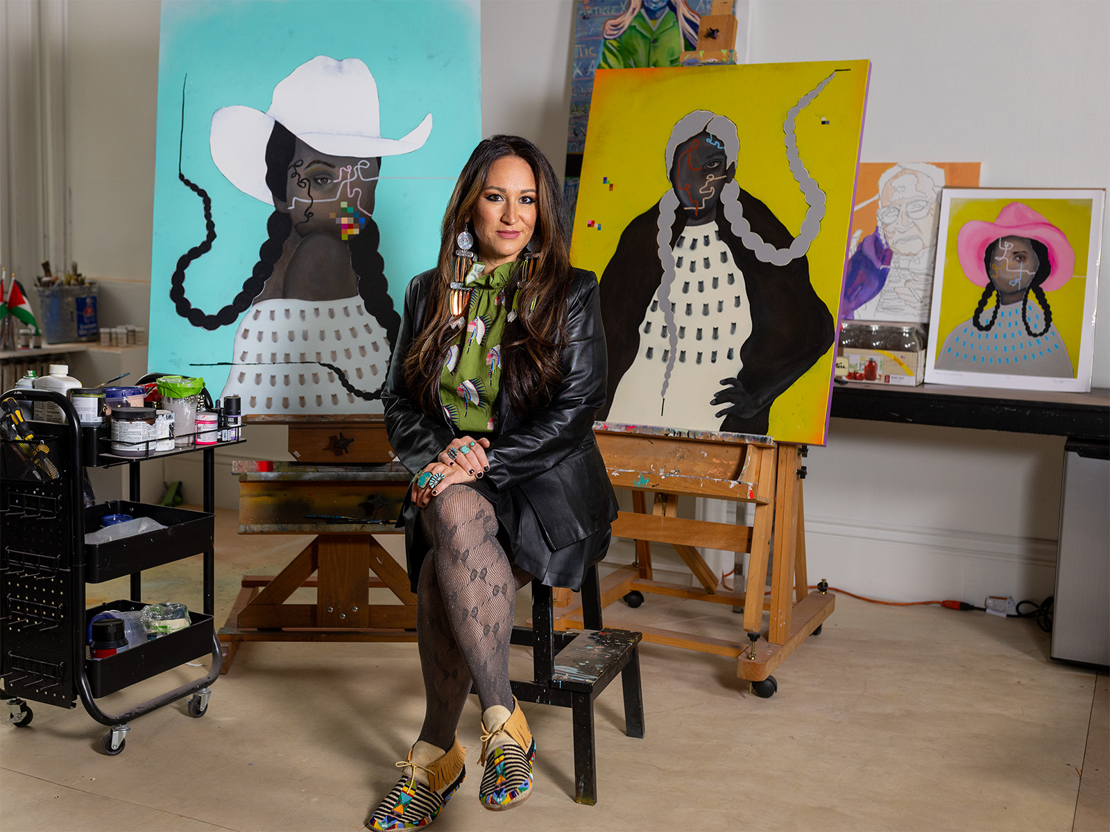 Danielle SeeWalker in front of her paintings