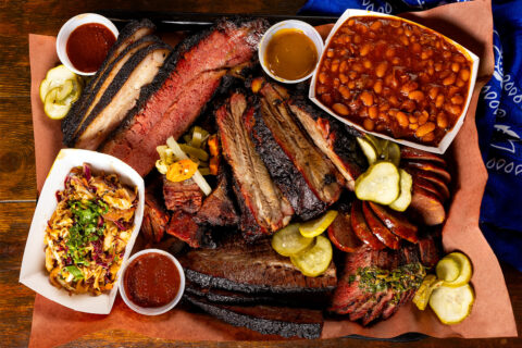 Meats and sides on a wood table