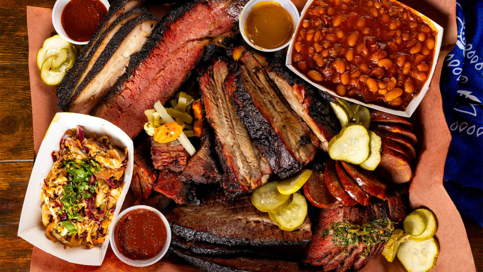 Meats and sides on a wood table