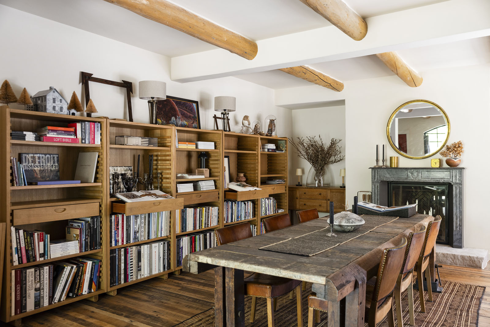 Dining room with a wall of bookshelves and exposed beams