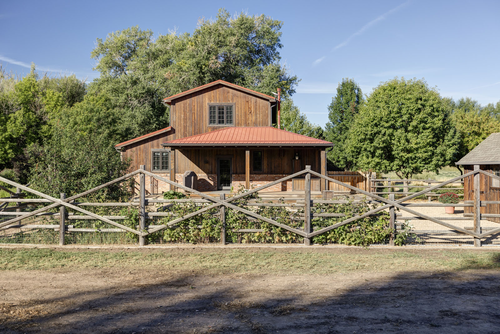 Farmhouse facade with a wooden fence in front