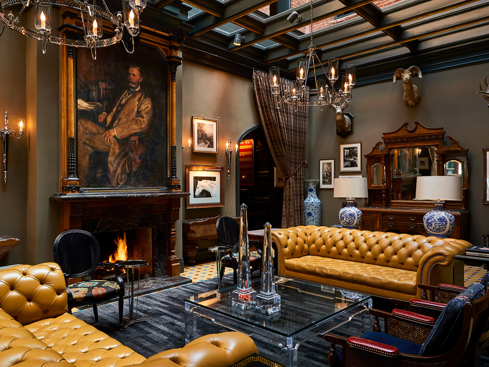Ornate lobby sitting area with leather couches and a fireplace
