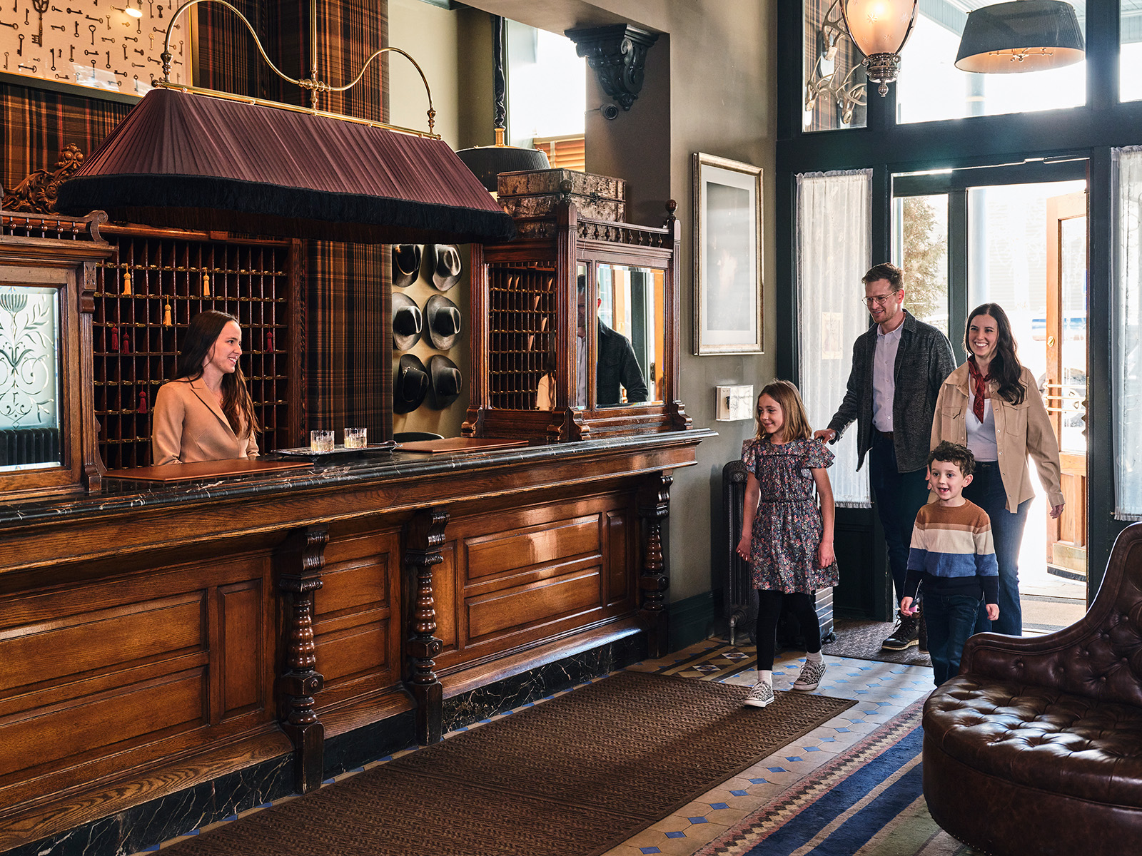 Family walking into HOtel Jerome lobby