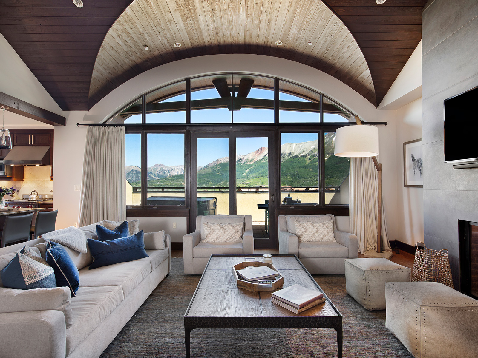 Living room with floor-to-ceiling windows and mountain views