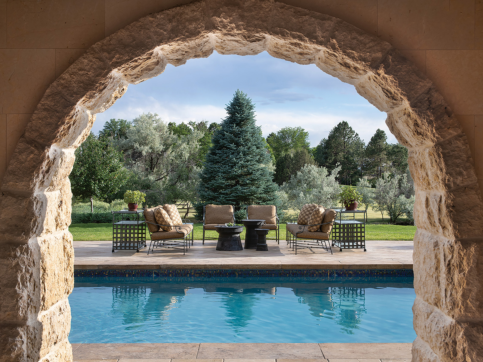 A view of the outdoor pool through an arch