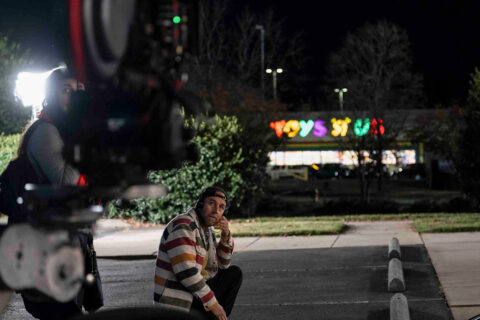 Derek Cianfrance sits in the parking lot of a Toys R Us with a camera