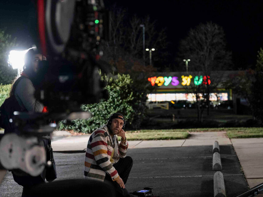 Derek Cianfrance sits in the parking lot of a Toys R Us with a camera
