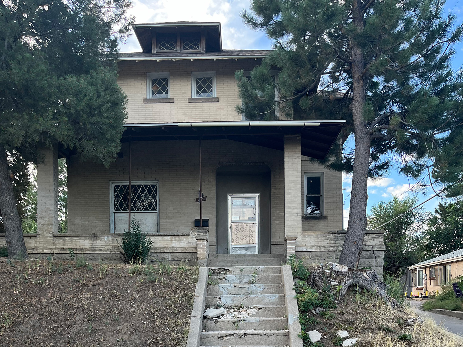 The exterior of a derelict two-story property