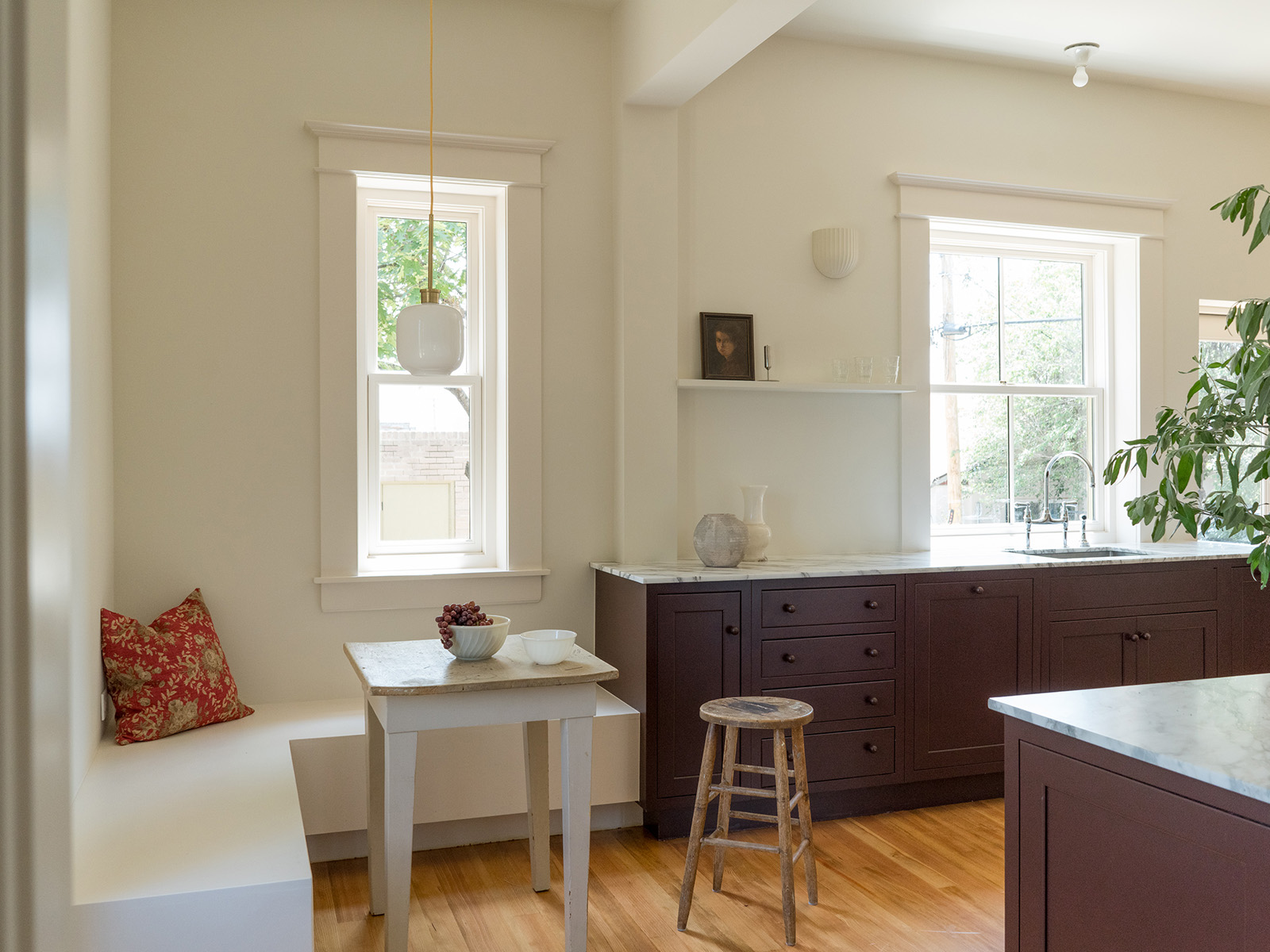 Sleek white modern kitchen with an eating nook