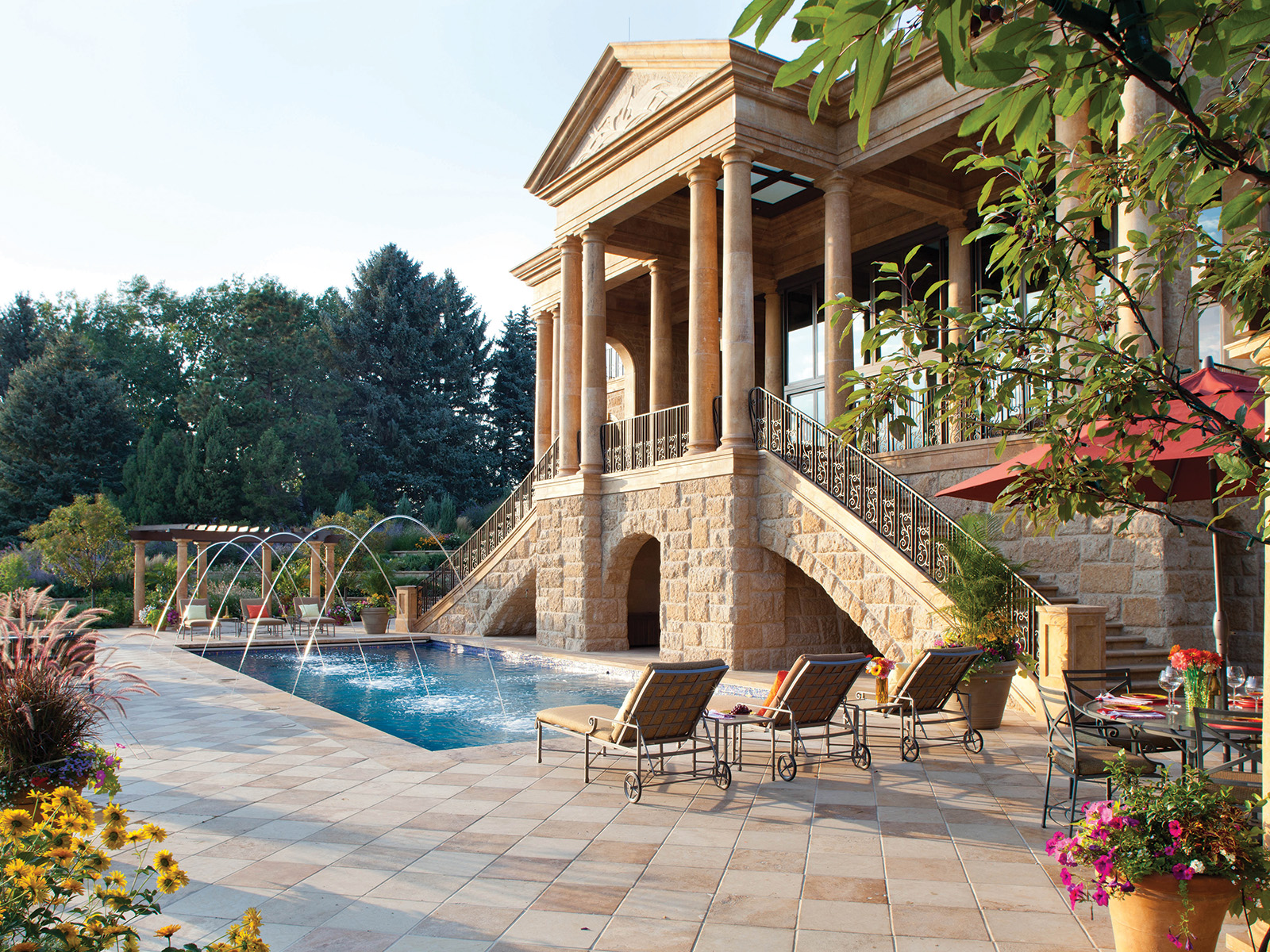 Outdoor pool in front of a neoclassical mansion