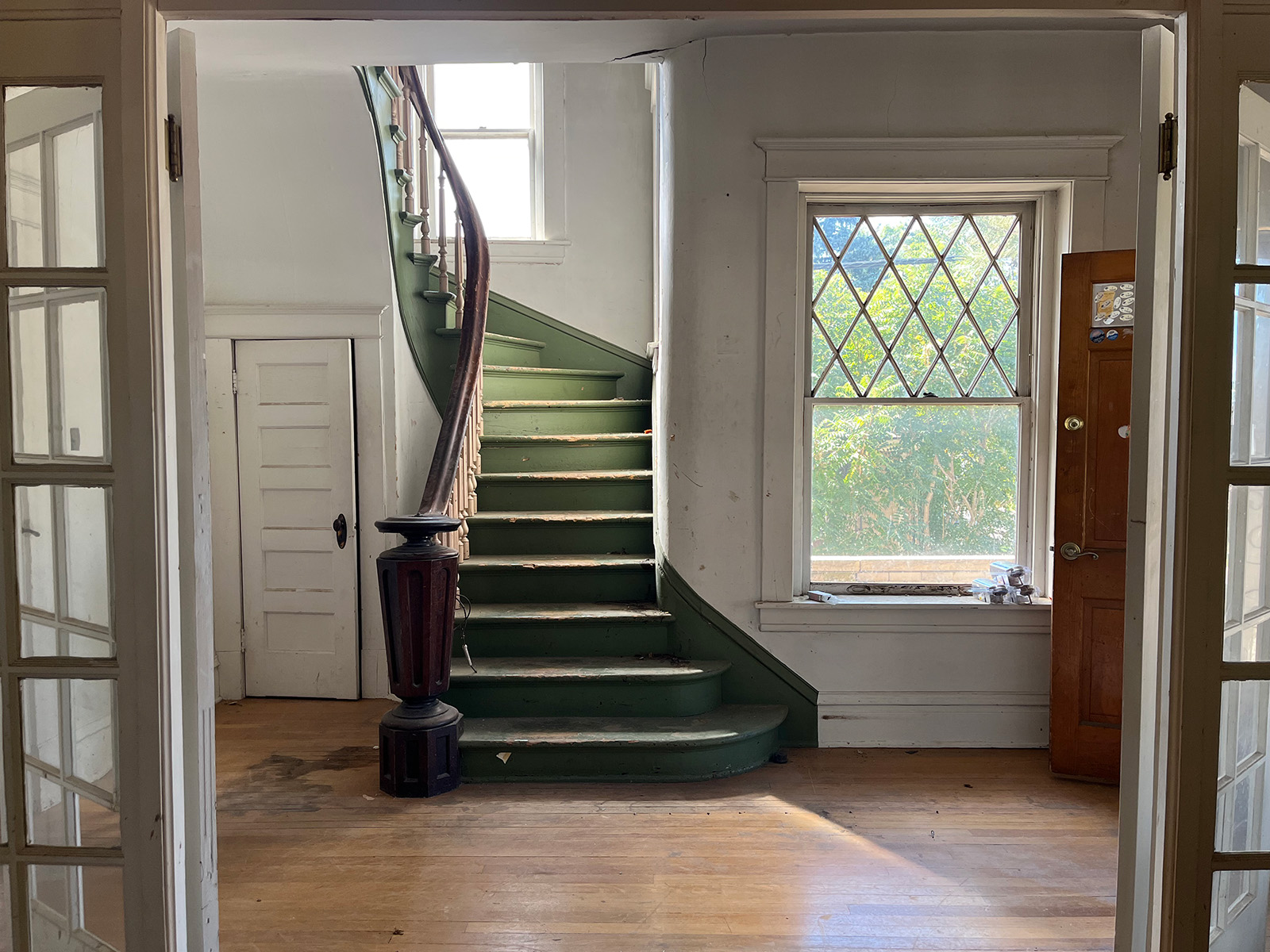 Spiral green staircase with peeling paint