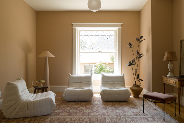 Peach-hued sitting room with a big window