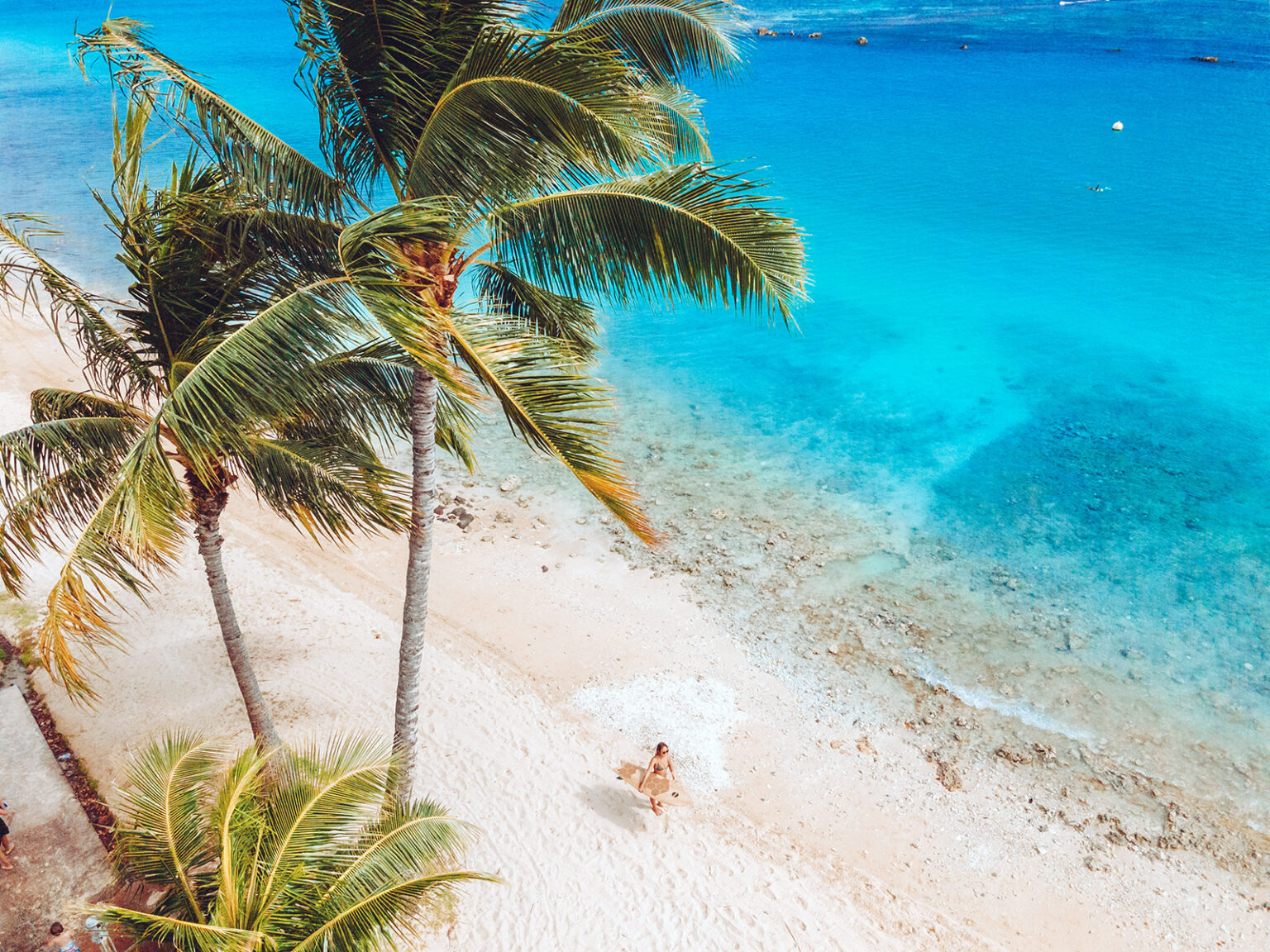 A surfer walking on a beach in Honolulu