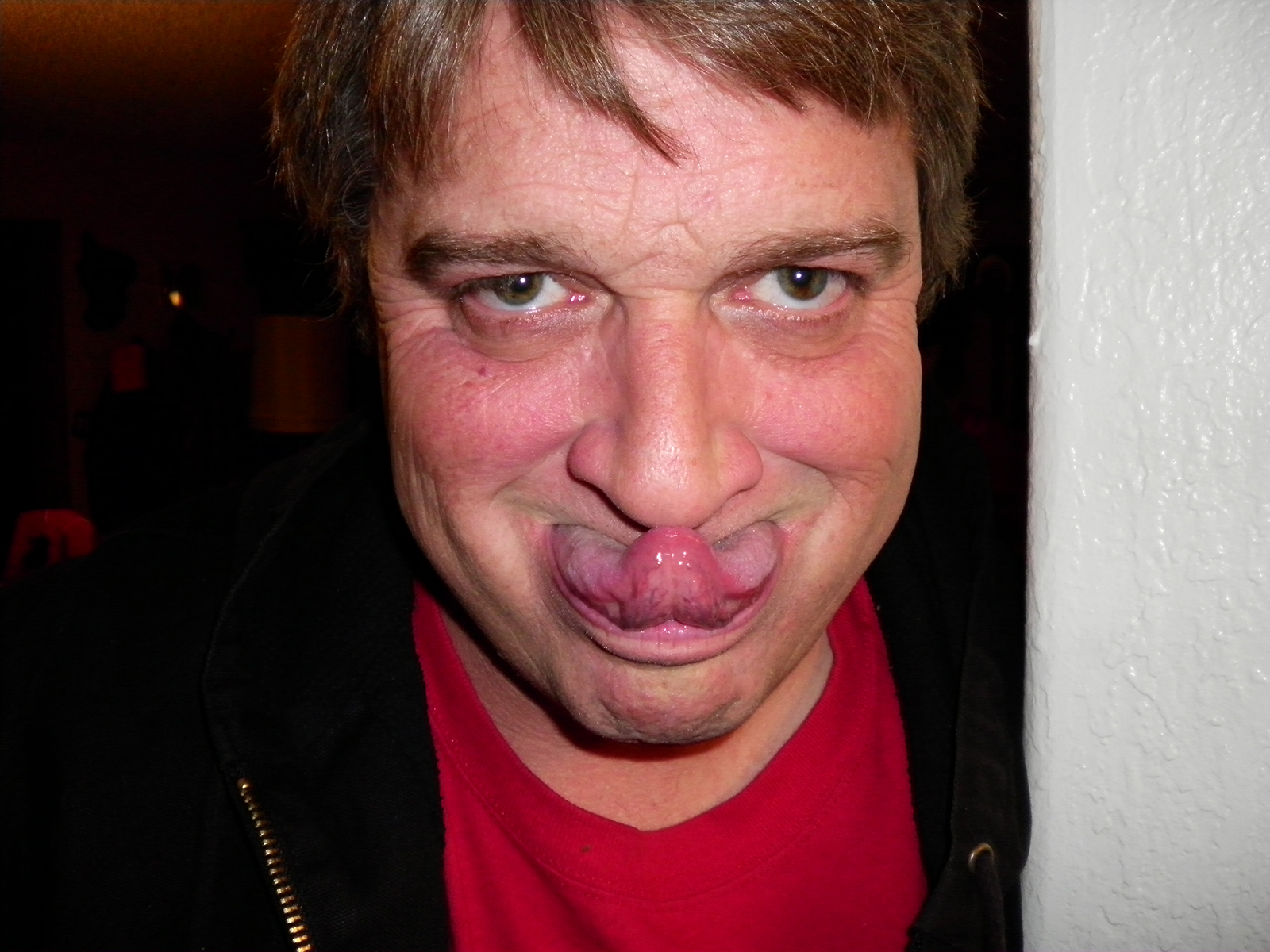 A creepy man touches his tongue to his nose