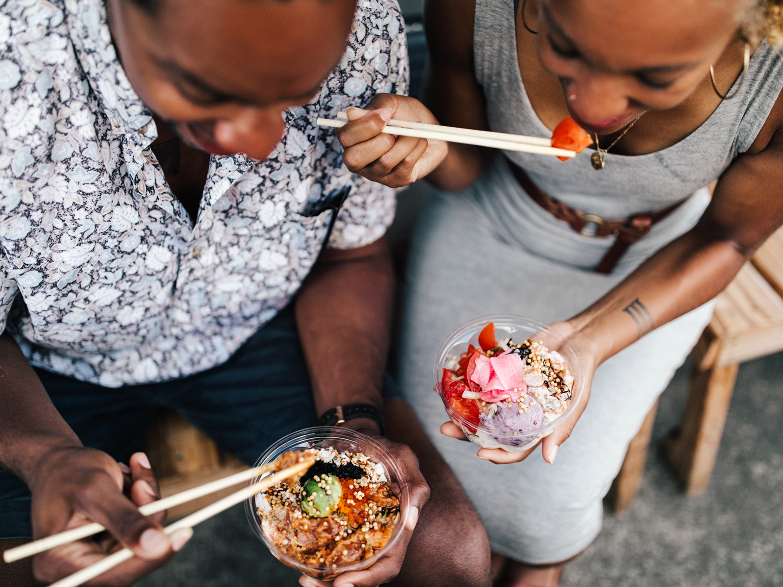 A couple eats fresh poke