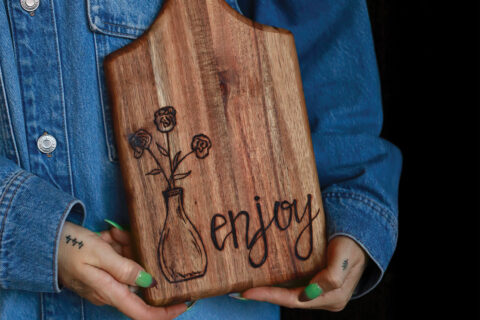 A wood-burned charcuterie board