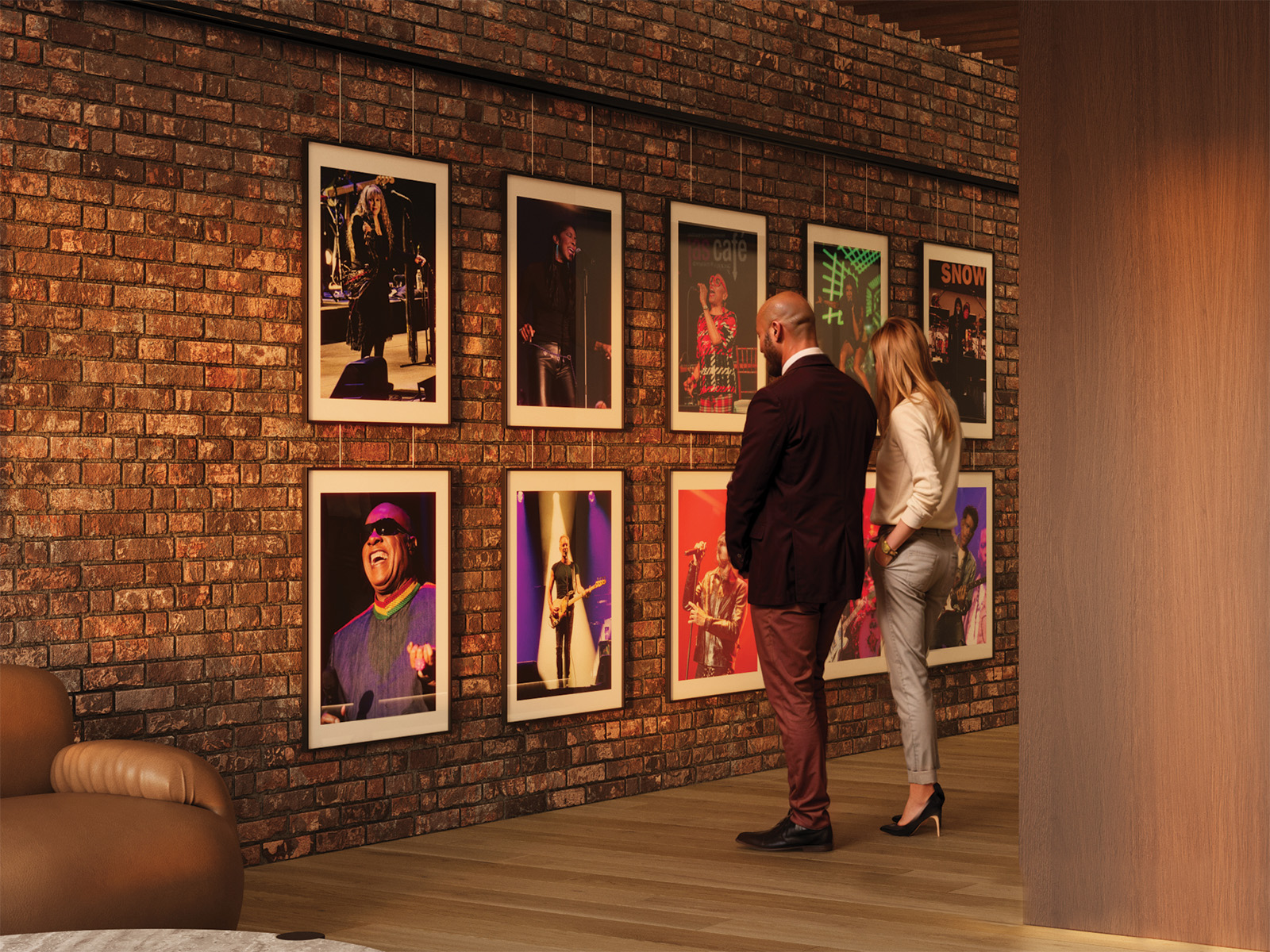 Two people looking at art on a brick wall